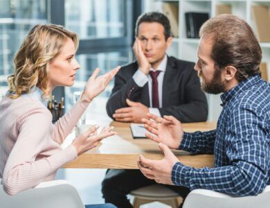 side view of couple arguing at workplace in lawyer office