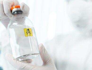 Competent researcher holding bottle with dangerous liquid