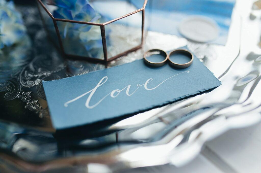Wedding rings at wedding invitation with decorations